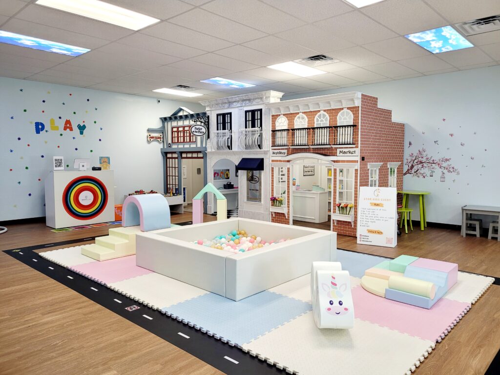 a room with a play area and a birthday party